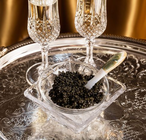 bowl of caviar with two glasses of champagne